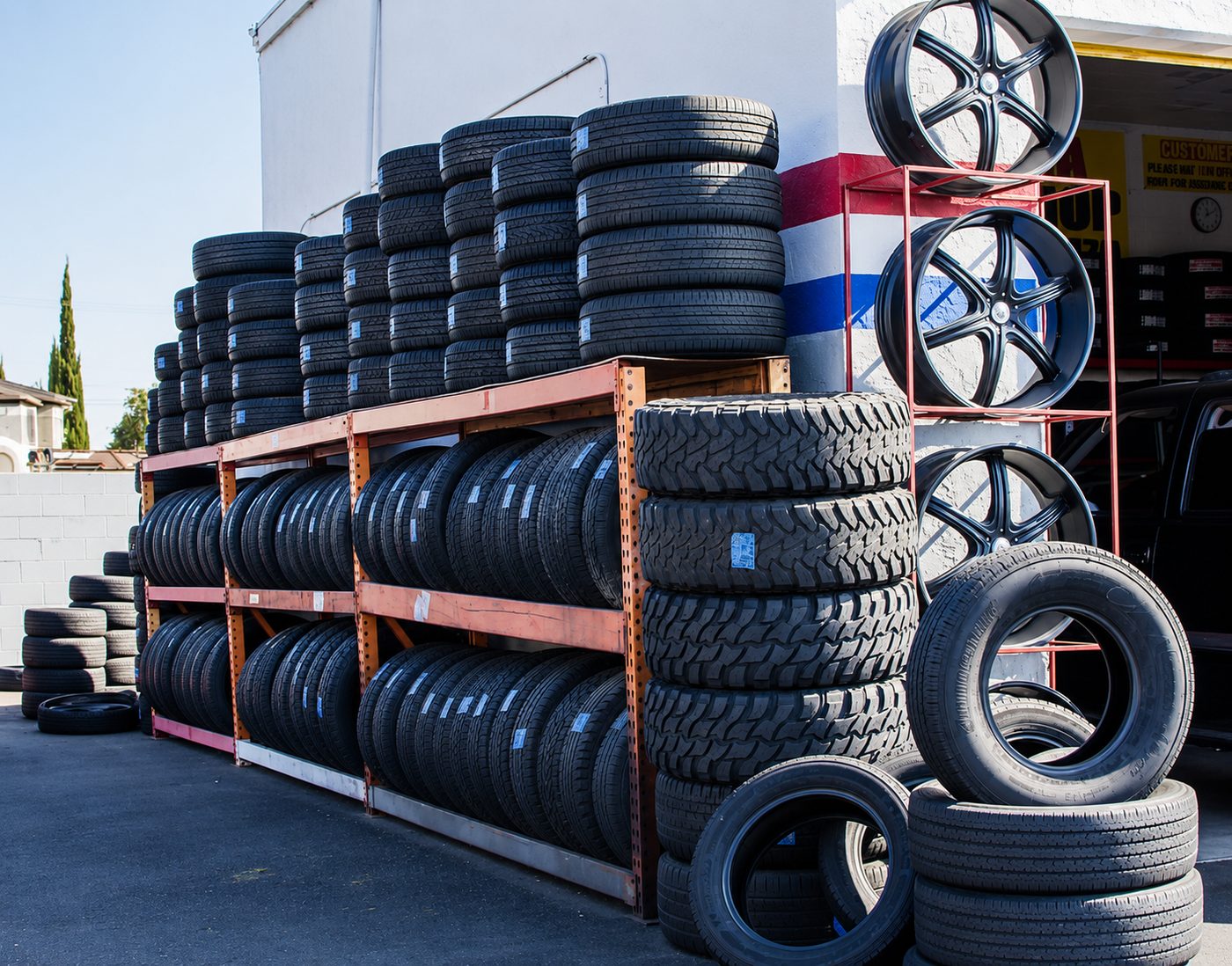 Racks of new tires and custom wheels outside the tire shop