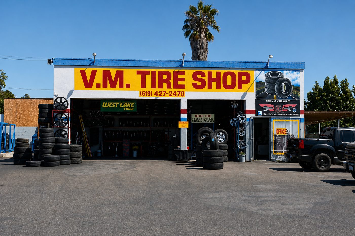 V.M. Tire Shop with new tires and wheels stacked out front